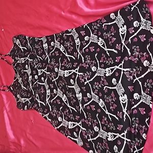Brand new spaghetti strap dress with flowers and skeletons.